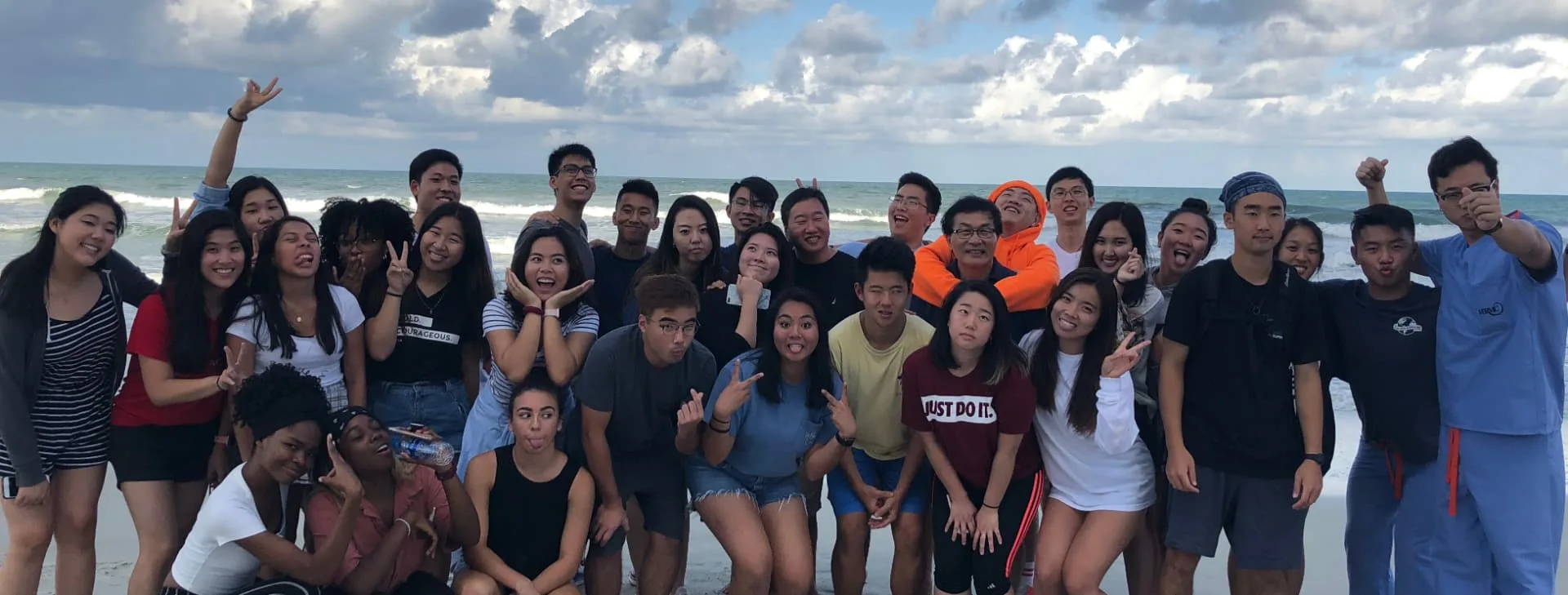 GMMA young adults gathered together by the ocean.